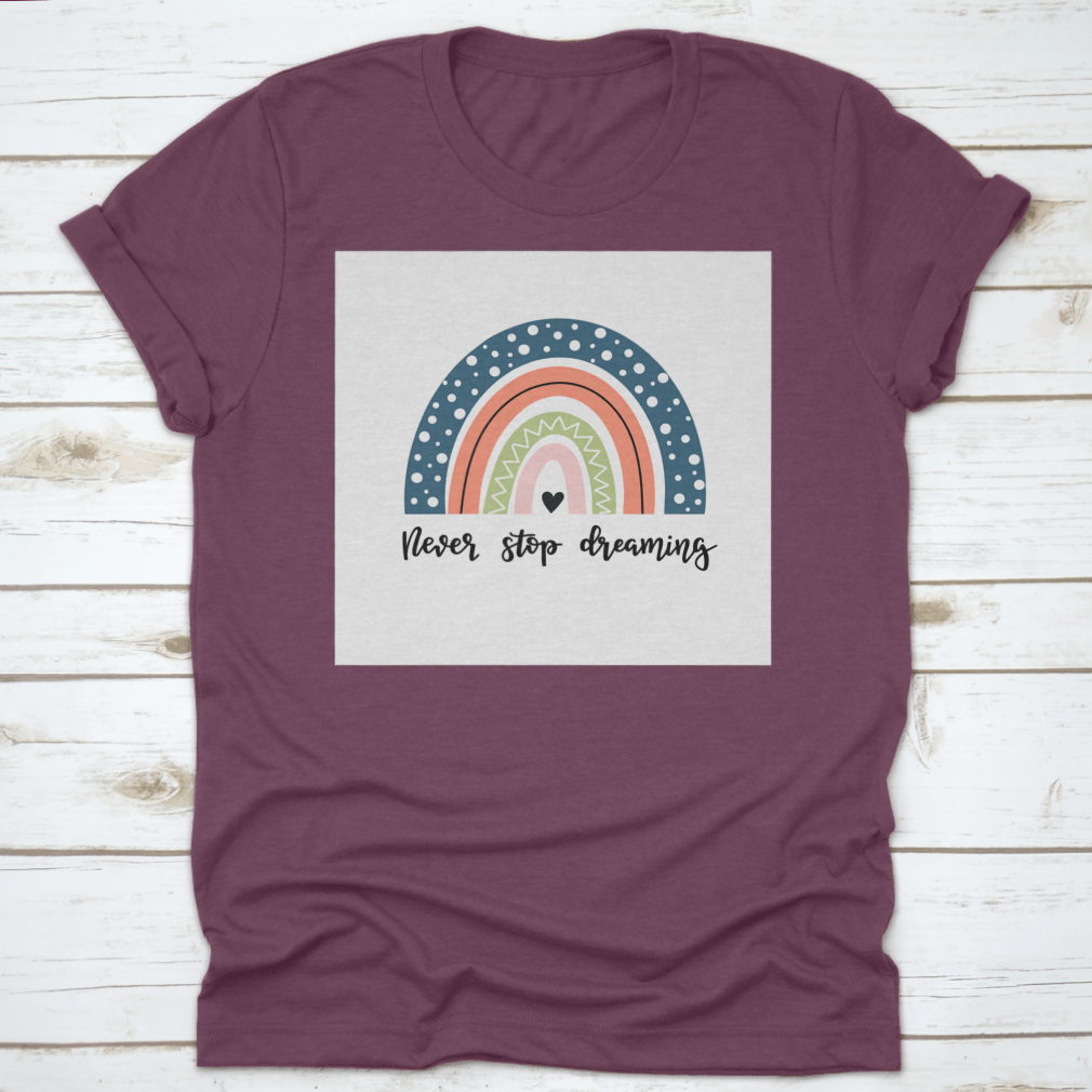 A colorful baby shirt featuring a rainbow design with the text 'Never Stop Dreaming' and 'Be Positive', made from soft cotton fabric.