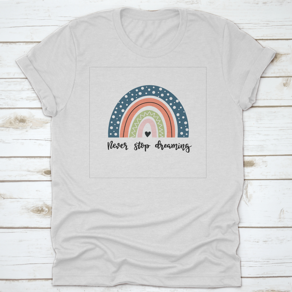 A colorful baby shirt featuring a rainbow design with the text 'Never Stop Dreaming' and 'Be Positive', made from soft cotton fabric.