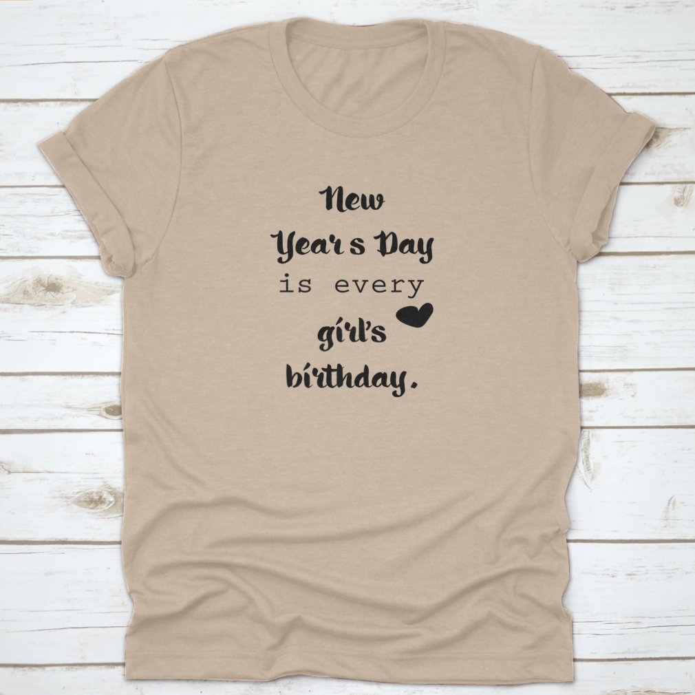 A motivational t-shirt featuring the quote 'New Year's Day Is Every Girl's Birthday', made from 100% cotton, displayed on a neutral background.