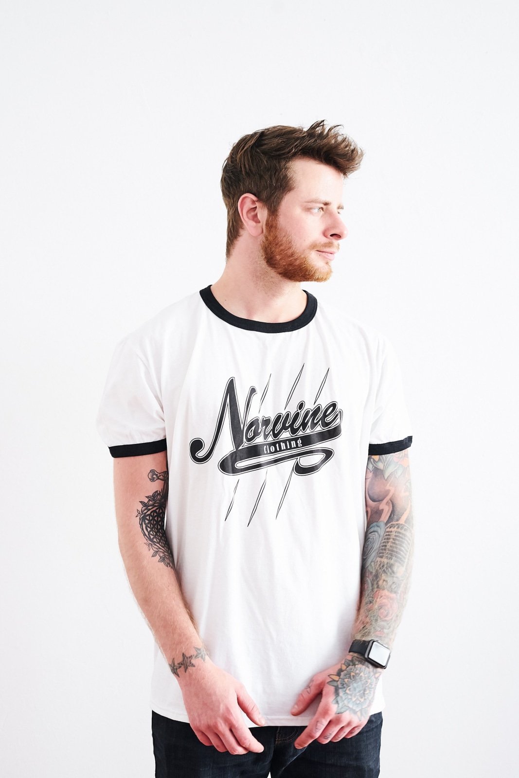 Norvine Campus Retro Ringer Tee featuring black stripes on a white organic cotton fabric, showcasing the Norvine logo on the back.