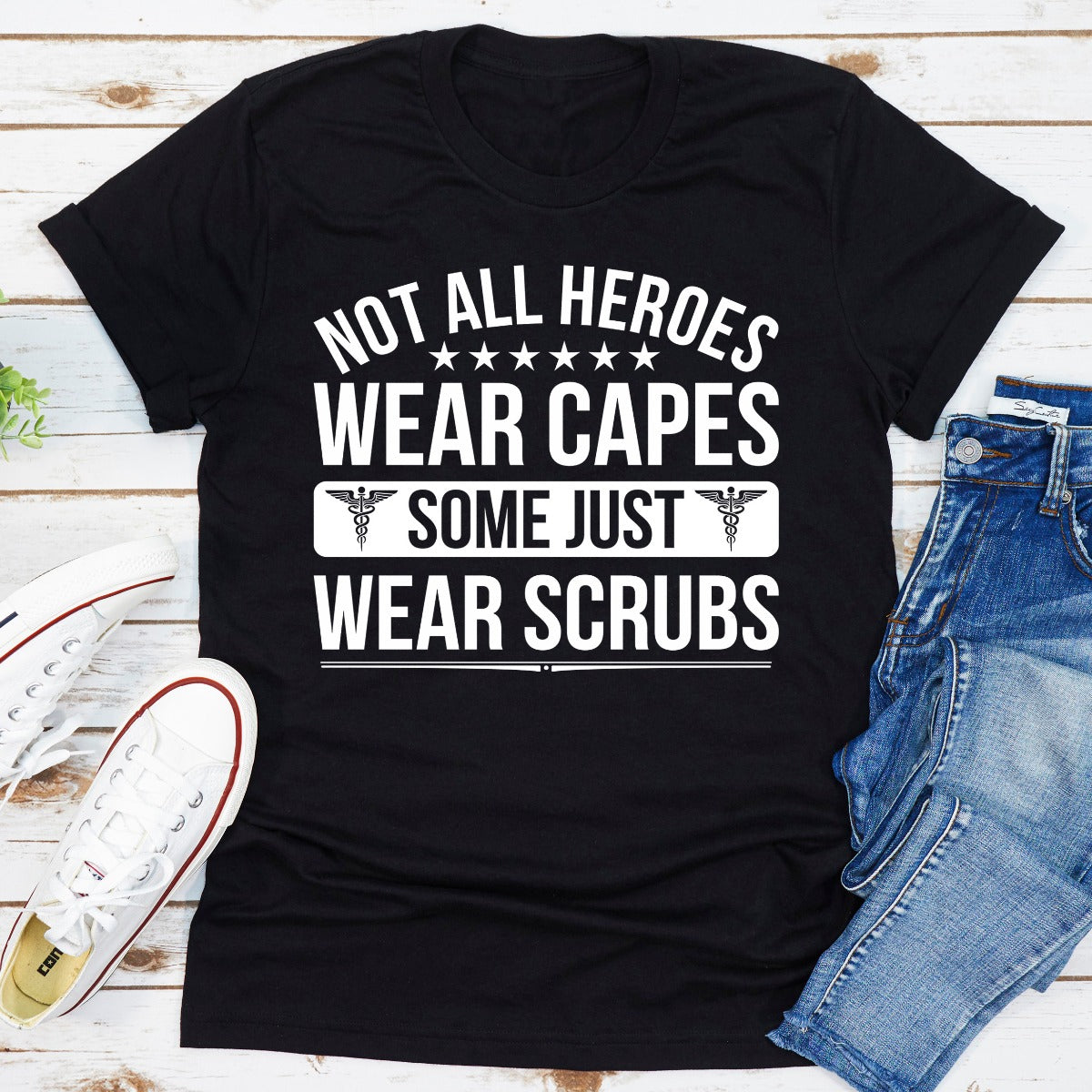 A soft cotton t-shirt featuring the phrase 'Not All Heroes Wear Capes Some Just Wear Scrubs', ideal for healthcare professionals.