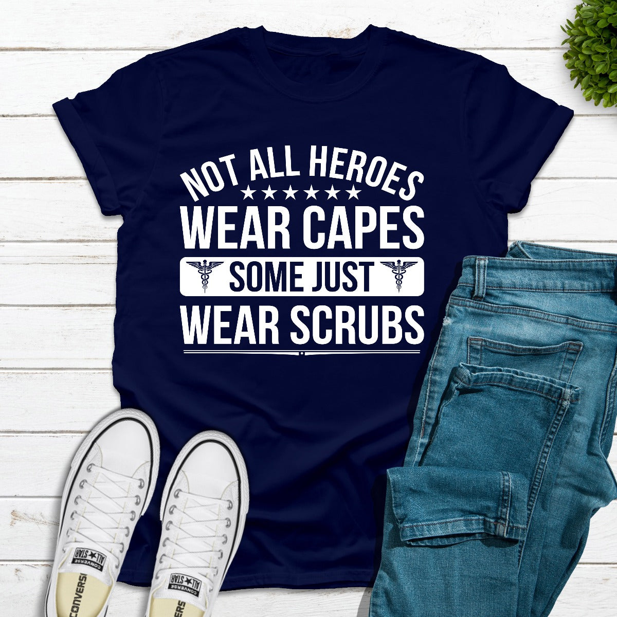 A soft cotton t-shirt featuring the phrase 'Not All Heroes Wear Capes Some Just Wear Scrubs', ideal for healthcare professionals.