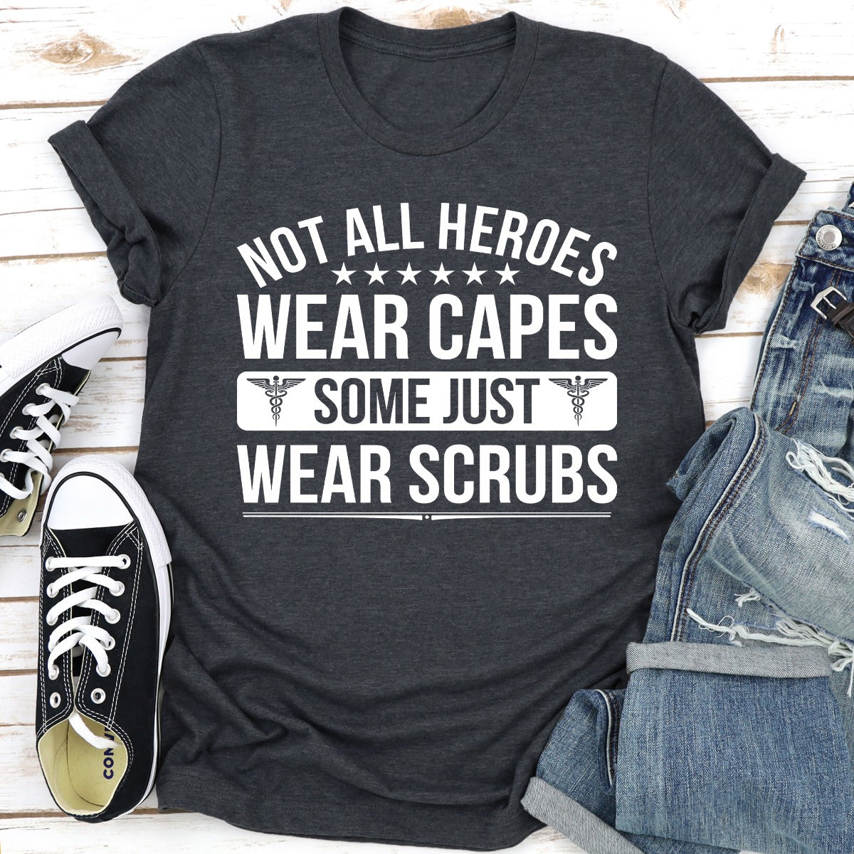 A soft cotton t-shirt featuring the phrase 'Not All Heroes Wear Capes Some Just Wear Scrubs', ideal for healthcare professionals.