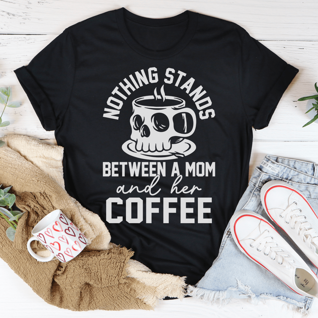 A stylish t-shirt featuring the phrase 'Nothing Stands Between A Mom & Her Coffee', made from soft cotton with double stitching.