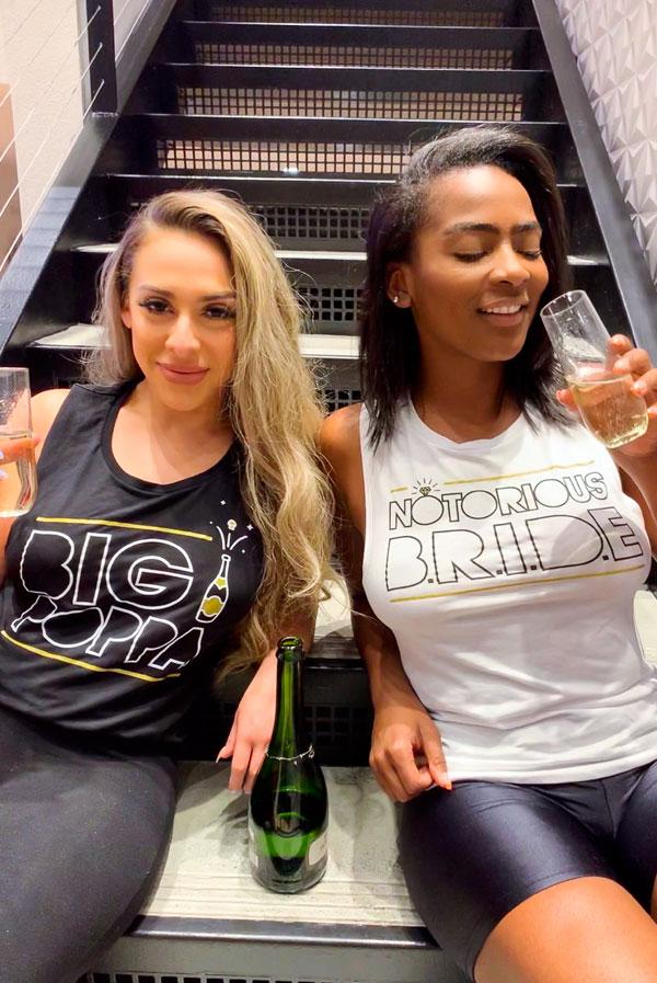 White and black muscle tank tops with 'Notorious Bride' and 'Big Poppa' printed designs, perfect for a bachelorette party.