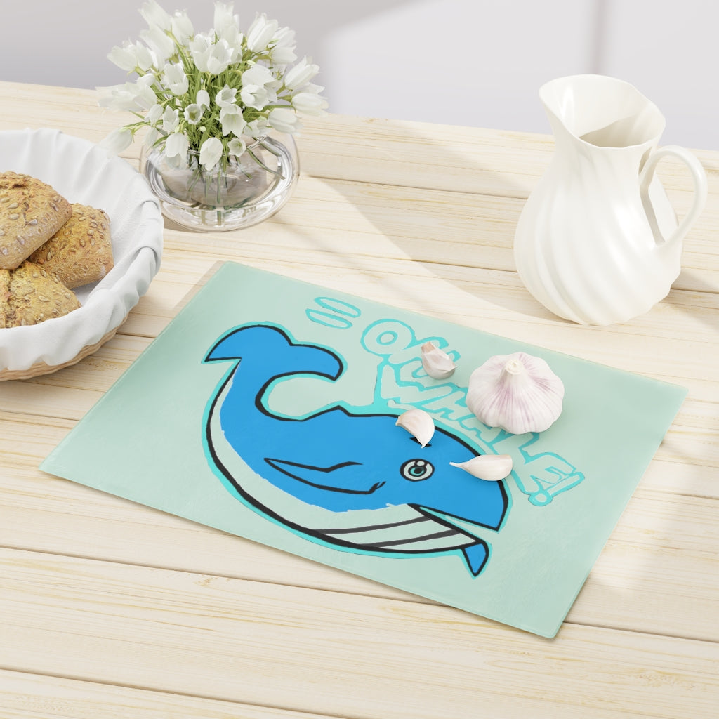 Oh Whale Cutting Board made of tempered glass with a charming whale design and rubber dots for stability.