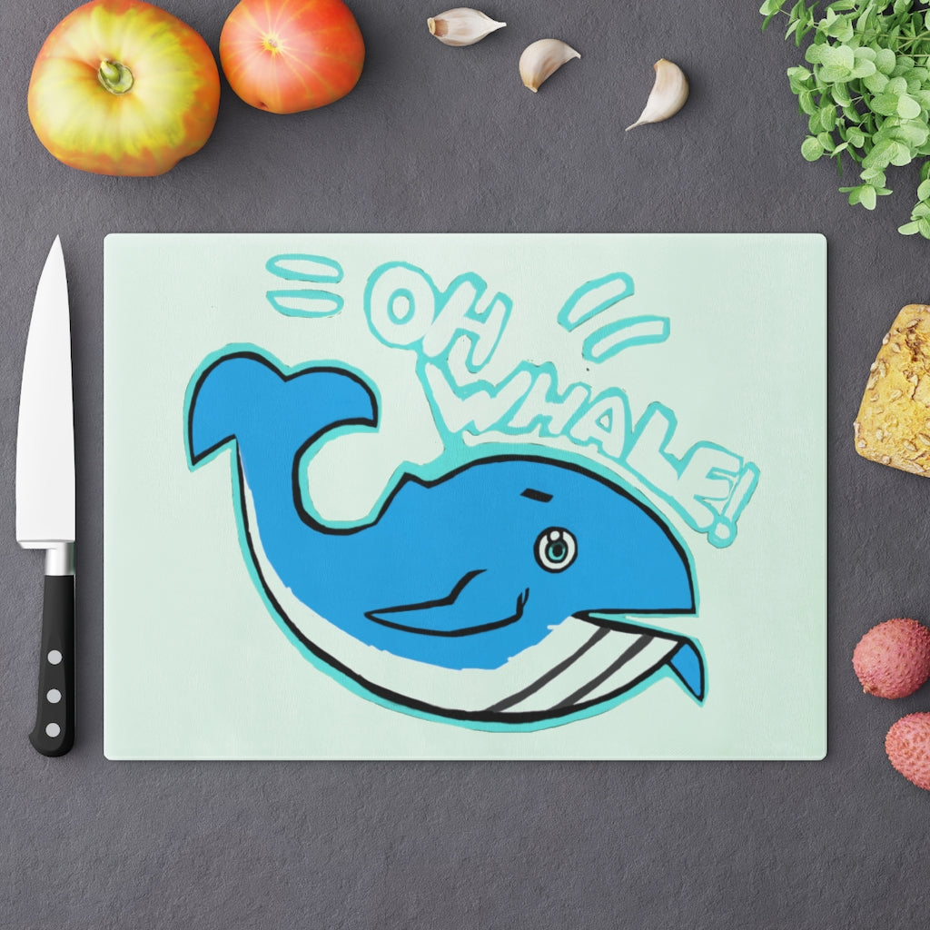 Oh Whale Cutting Board made of tempered glass with a charming whale design and rubber dots for stability.