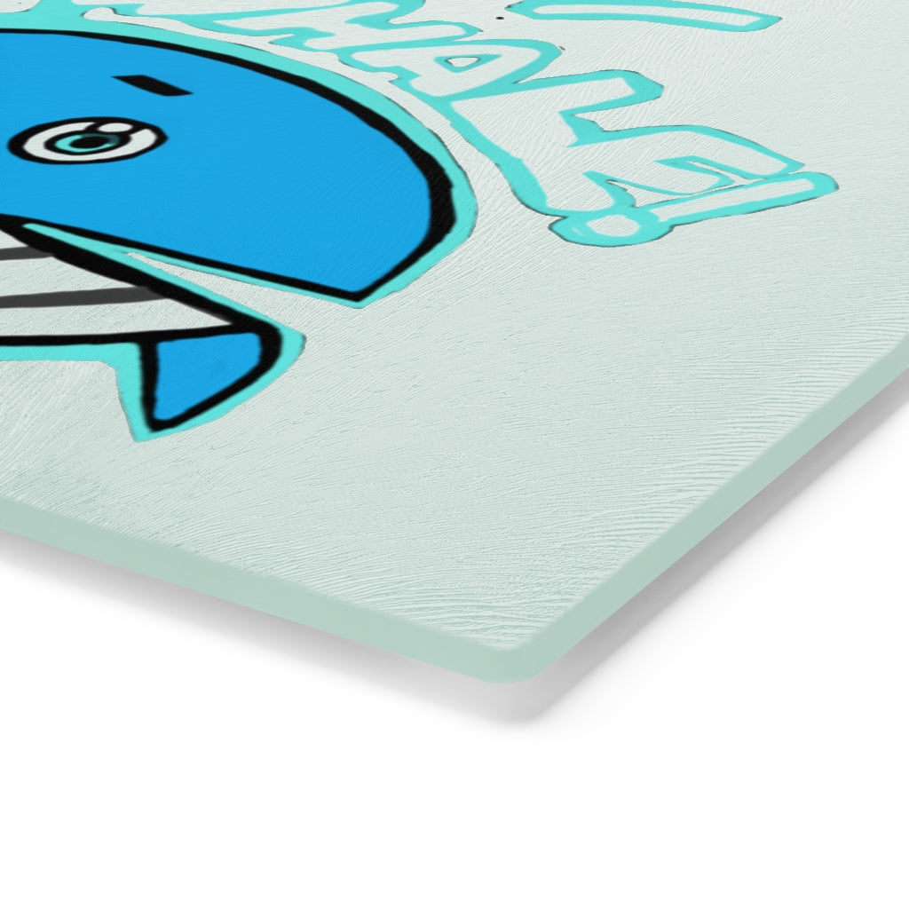 Oh Whale Cutting Board made of tempered glass with a charming whale design and rubber dots for stability.