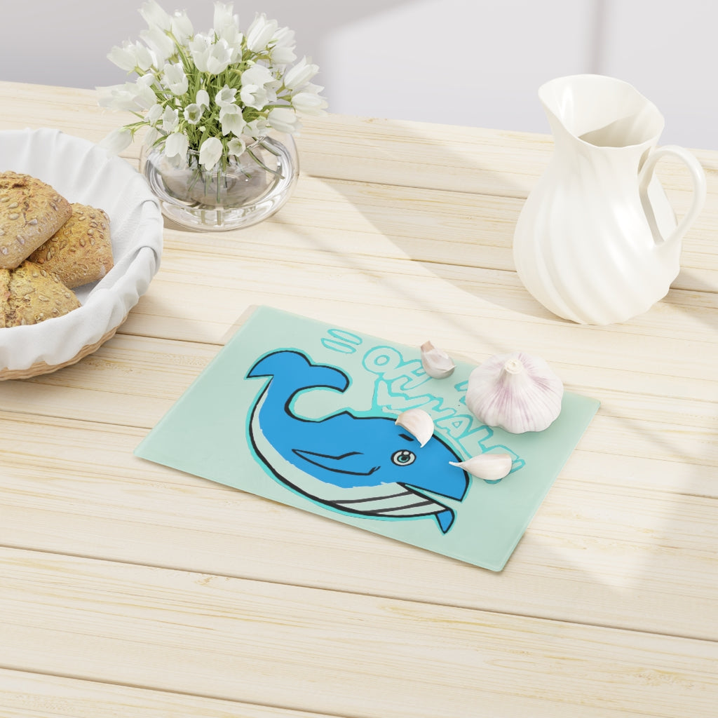 Oh Whale Cutting Board made of tempered glass with a charming whale design and rubber dots for stability.