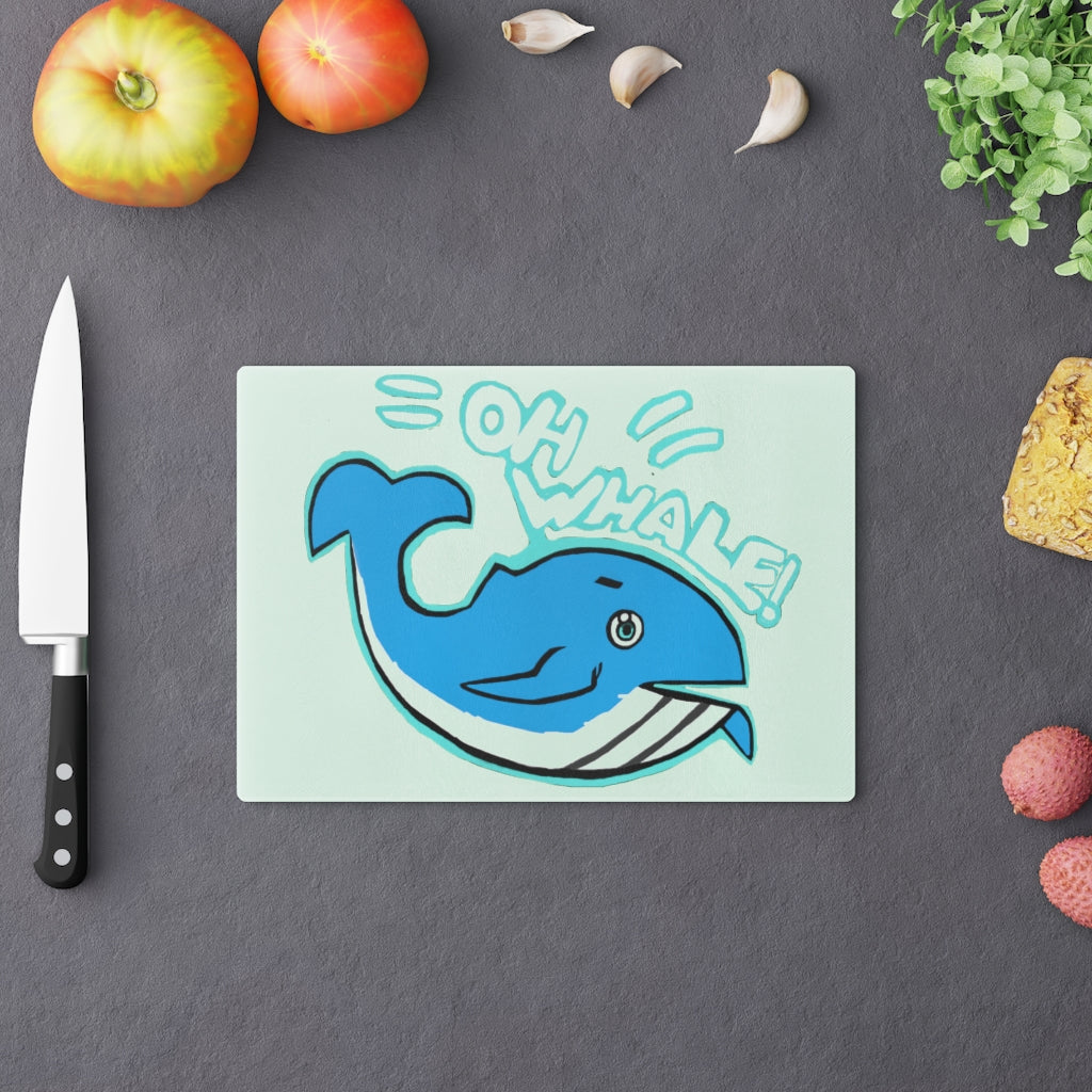 Oh Whale Cutting Board made of tempered glass with a charming whale design and rubber dots for stability.