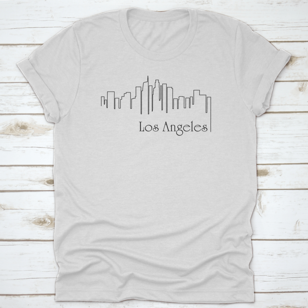 A stylish t-shirt featuring a one-line illustration of Los Angeles with an abstract background, showcasing a modern and artistic design.