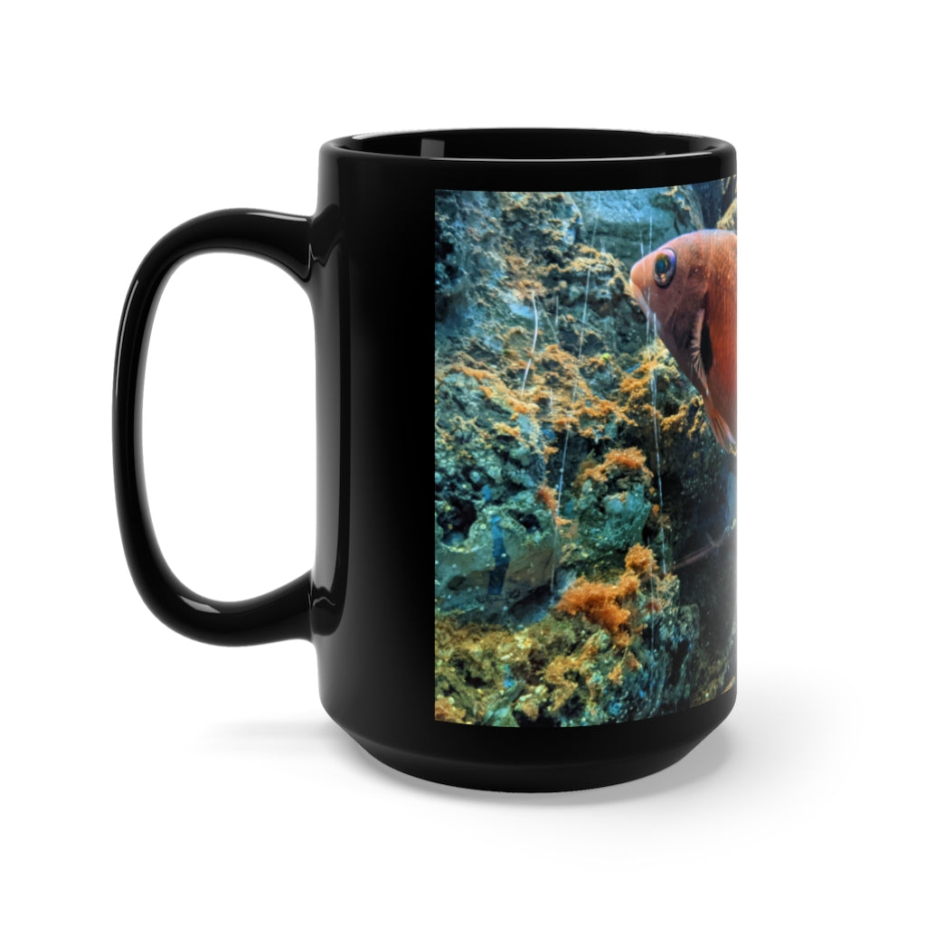 A stylish black ceramic mug with an orange fish design, holding 15 ounces of liquid, perfect for coffee and tea lovers.