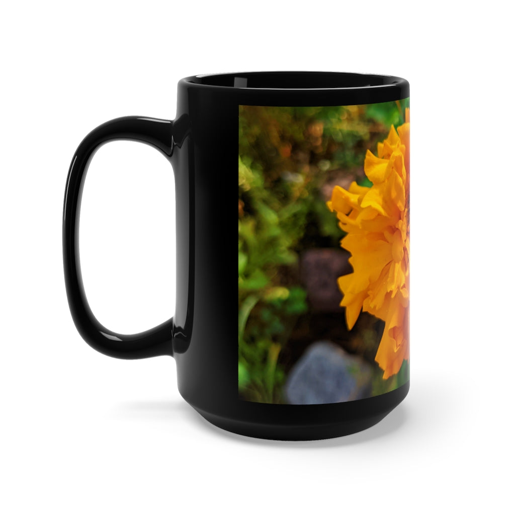 A stylish 15oz black ceramic mug featuring an orange flower design, perfect for coffee and tea lovers.