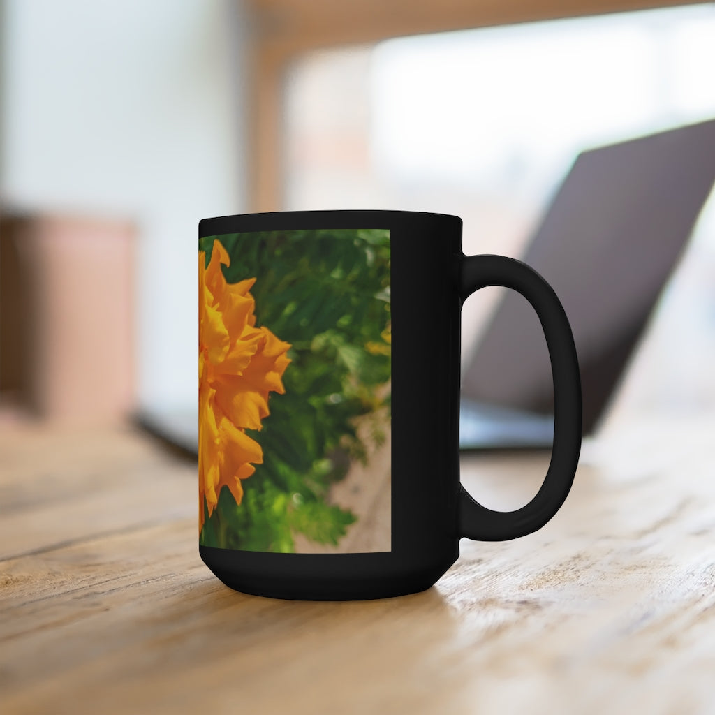 A stylish 15oz black ceramic mug featuring an orange flower design, perfect for coffee and tea lovers.