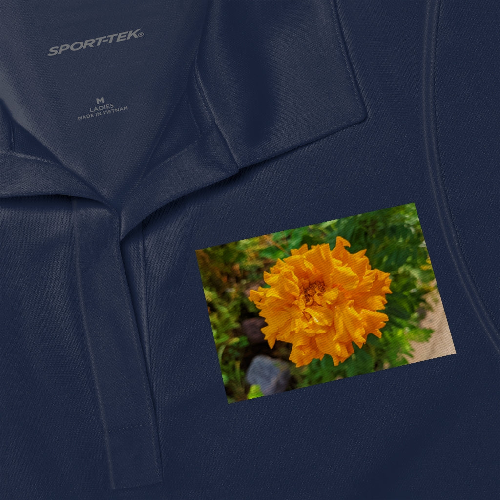 A stylish Orange Flower Women's Polo Shirt made from lightweight, snag-resistant fabric, featuring a tapered neck design.