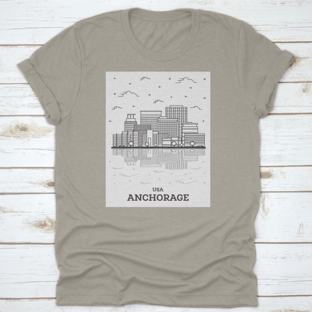 A stylish t-shirt featuring the skyline of Anchorage, Alaska, showcasing modern buildings against a clear sky.