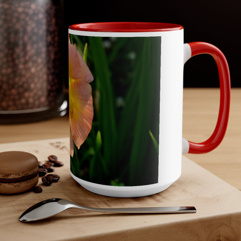 A ceramic mug featuring a peach and yellow flower design with a white exterior and colored interior, showcasing its vibrant colors and comfortable C-handle.