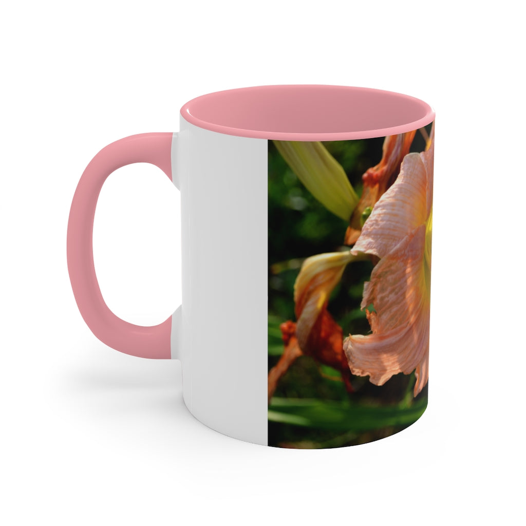 A ceramic mug featuring a peach and yellow flower design with a white exterior and colored interior, showcasing its vibrant colors and comfortable C-handle.