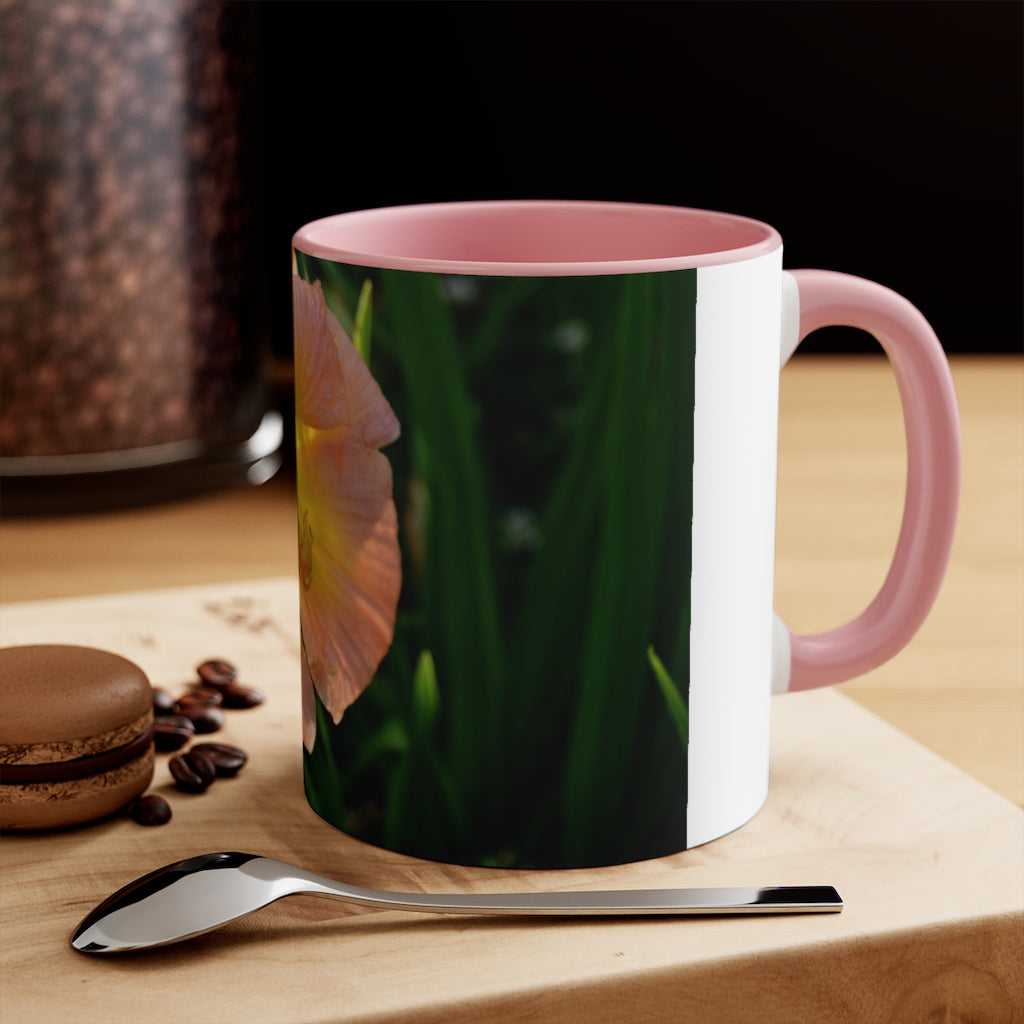 A ceramic mug featuring a peach and yellow flower design with a white exterior and colored interior, showcasing its vibrant colors and comfortable C-handle.