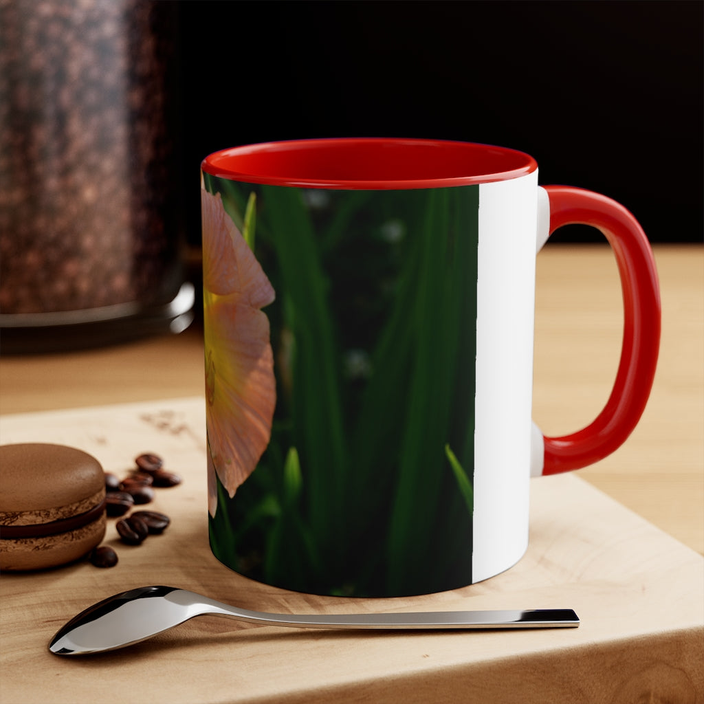 A ceramic mug featuring a peach and yellow flower design with a white exterior and colored interior, showcasing its vibrant colors and comfortable C-handle.