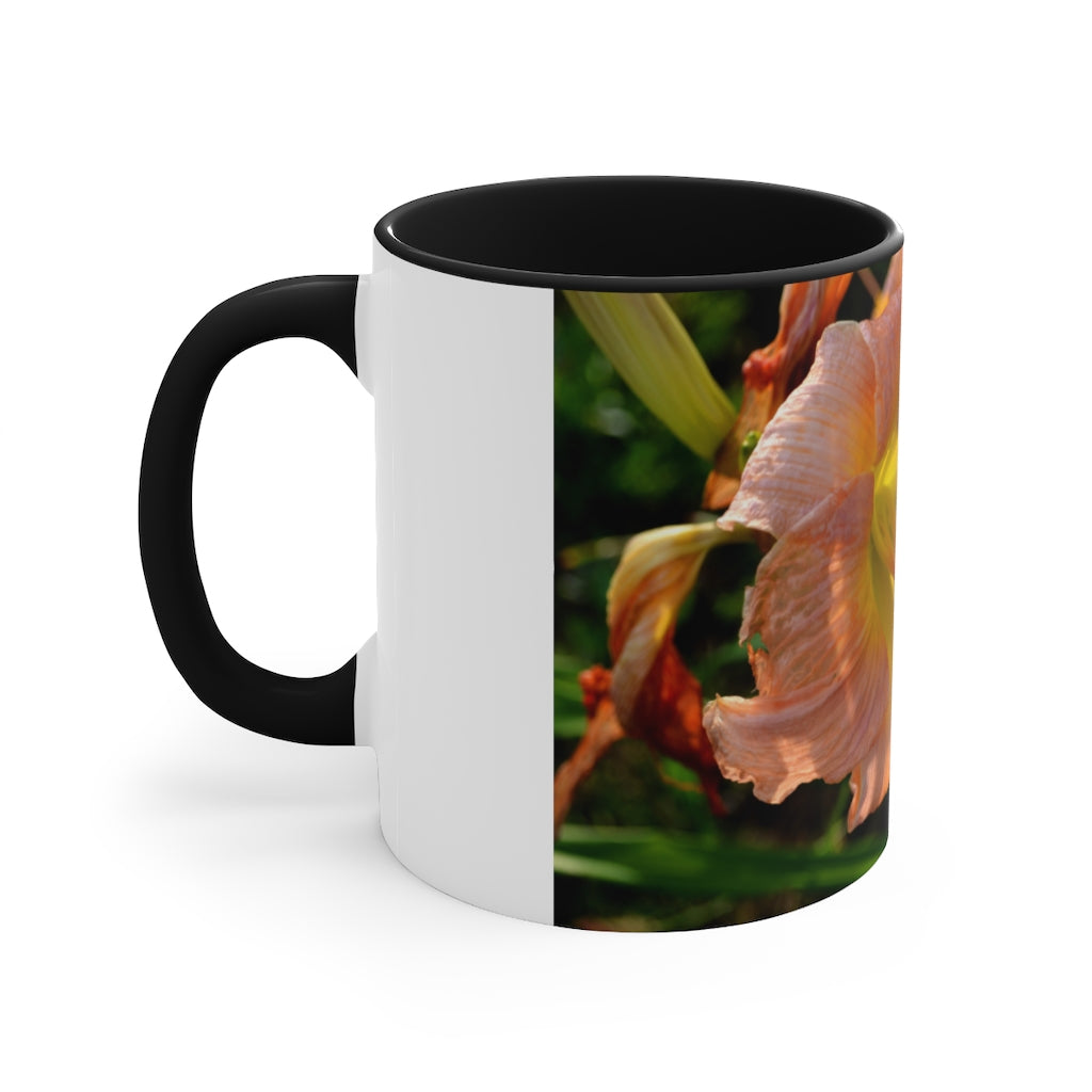 A ceramic mug featuring a peach and yellow flower design with a white exterior and colored interior, showcasing its vibrant colors and comfortable C-handle.