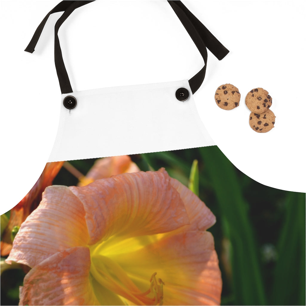 Peach and yellow flower apron with black detachable twill straps, perfect for cooking.