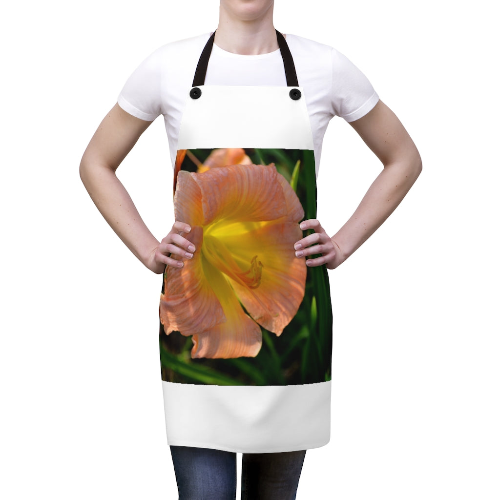 Peach and yellow flower apron with black detachable twill straps, perfect for cooking.