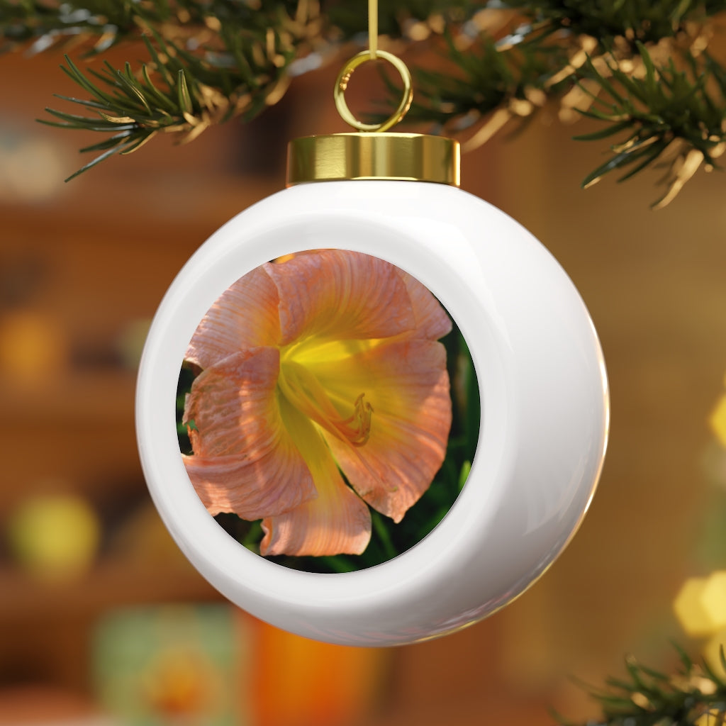 A beautiful 3-inch Christmas ball ornament featuring peach and yellow flowers with a glossy finish and gold ribbon for hanging.