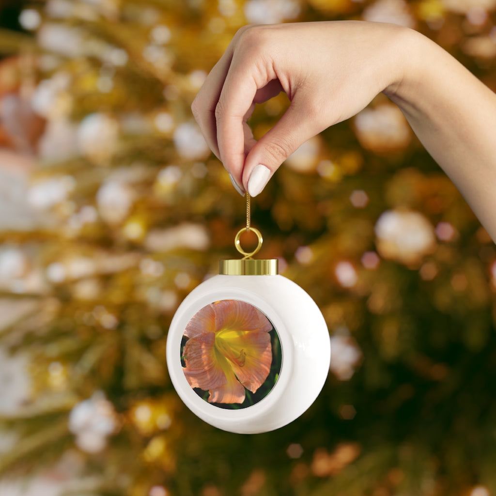 A beautiful 3-inch Christmas ball ornament featuring peach and yellow flowers with a glossy finish and gold ribbon for hanging.