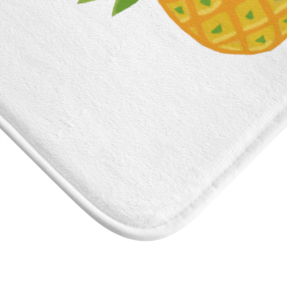 A vibrant pineapple bath mat with anti-slip backing, showcasing a tropical design perfect for bathroom decor.