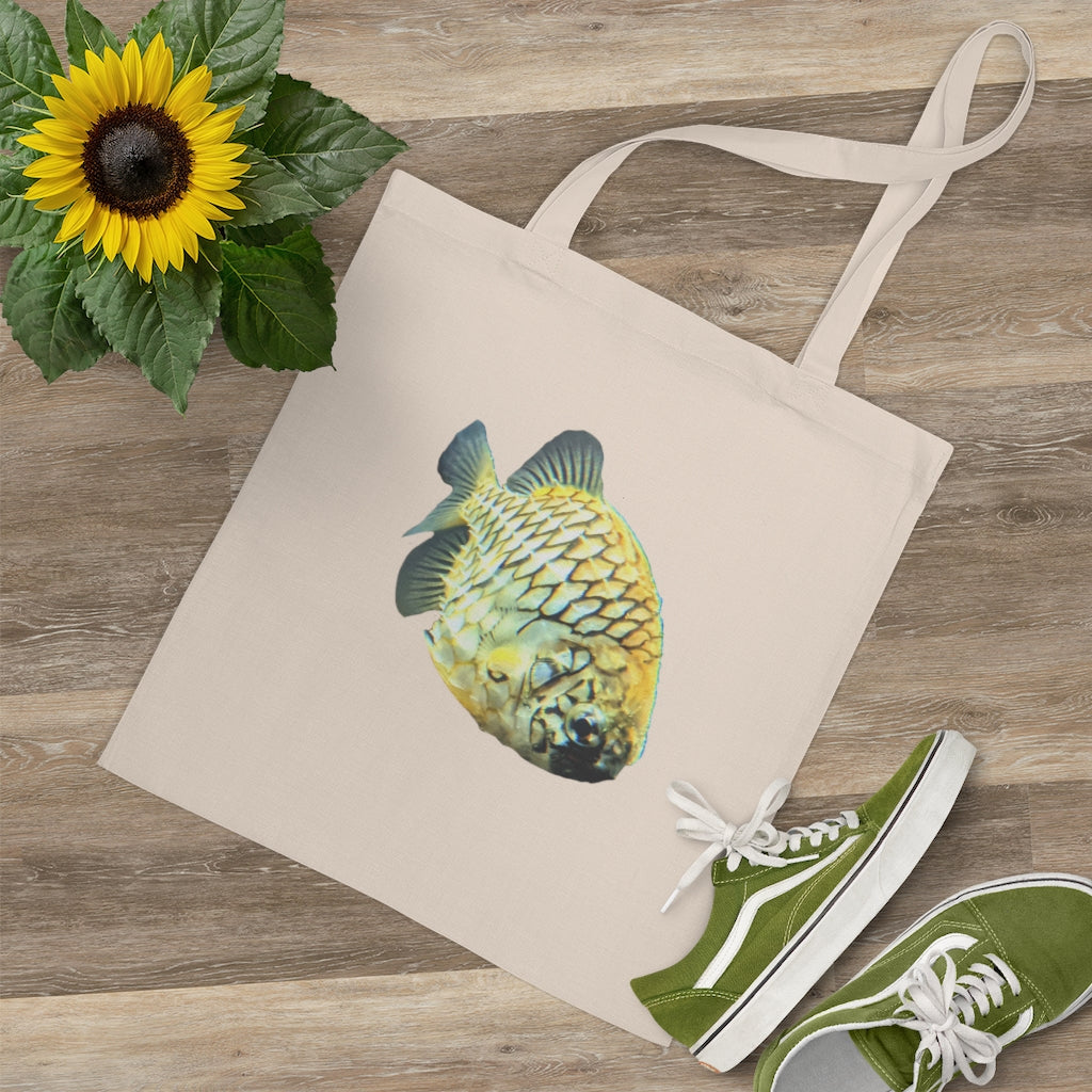 A vibrant Pineapple Fish Tote Bag made of 100% cotton, featuring long handles and cross stitching for added stability.