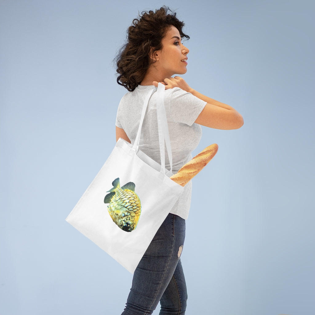 A vibrant Pineapple Fish Tote Bag made of 100% cotton, featuring long handles and cross stitching for added stability.