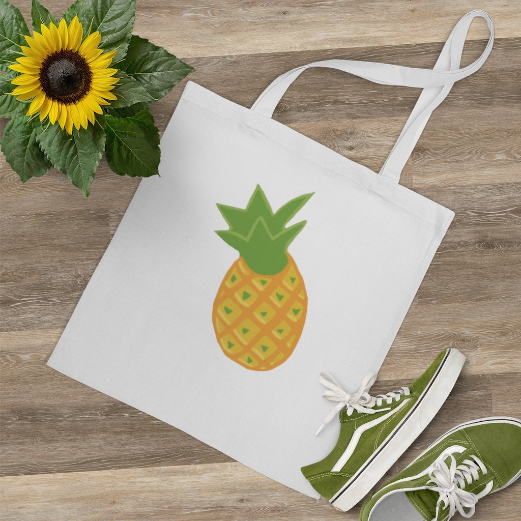 A vibrant Pineapple Tote Bag made of 100% cotton with long handles and cross stitching for added durability.