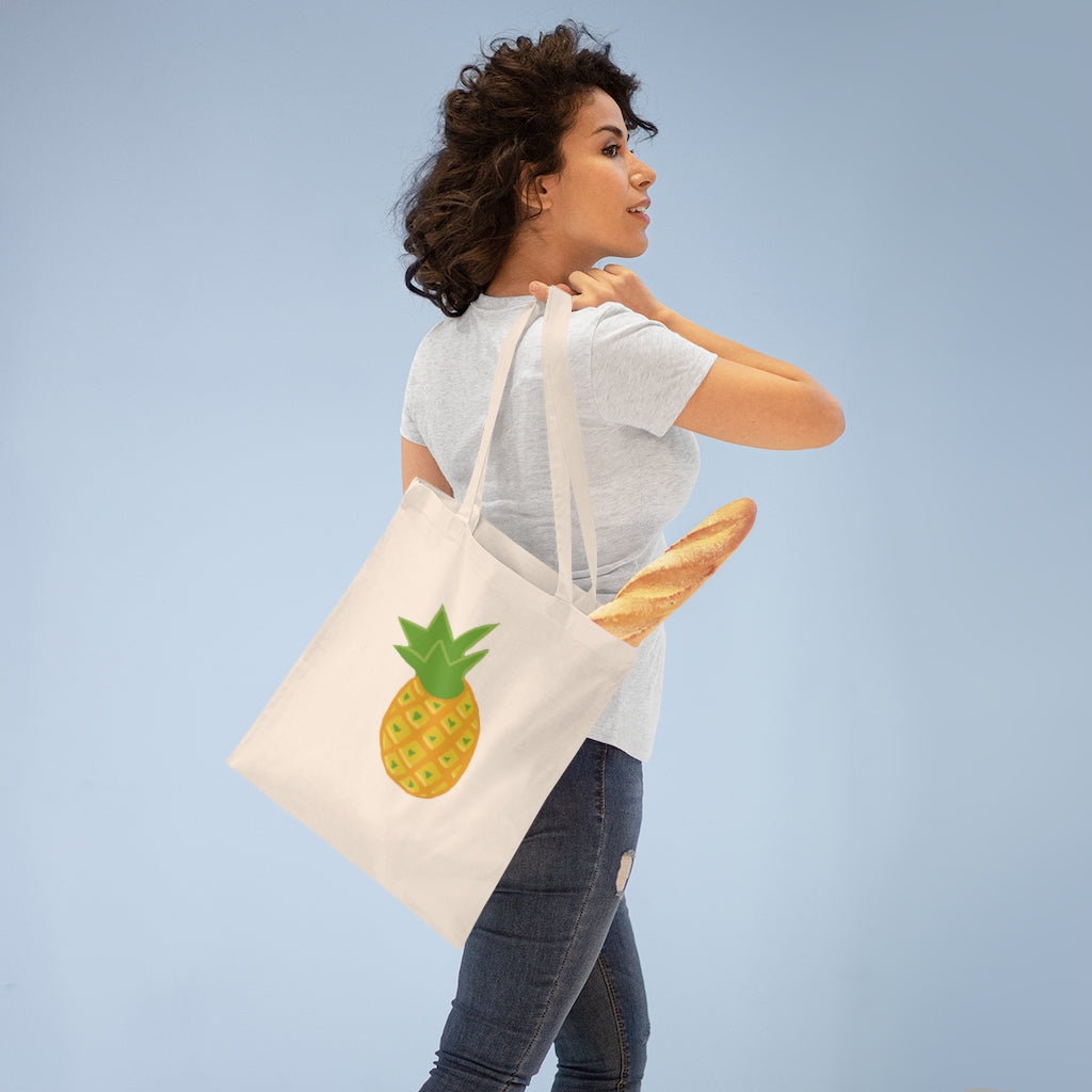 A vibrant Pineapple Tote Bag made of 100% cotton with long handles and cross stitching for added durability.