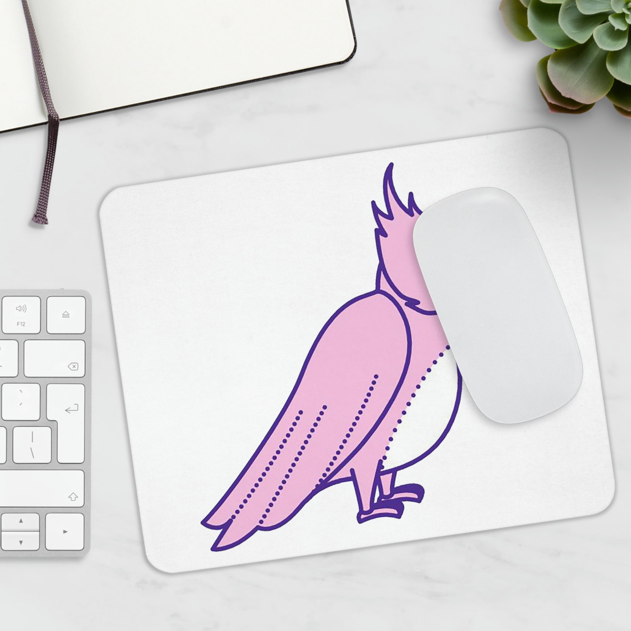 A vibrant pink and purple mouse pad featuring a beautiful bird design, perfect for enhancing any workspace.