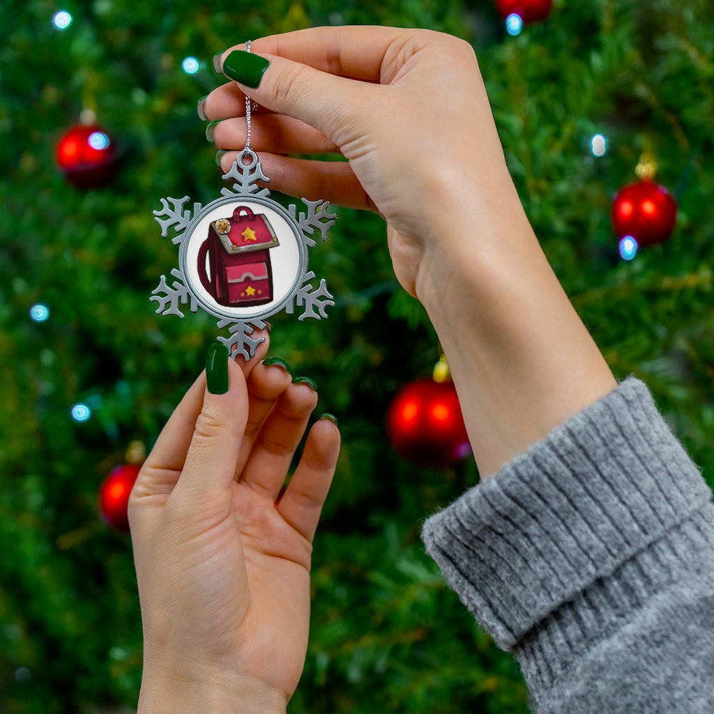 A beautifully crafted Pink Bag Pewter Snowflake Ornament with a silver-toned hanging string, showcasing intricate snowflake details.