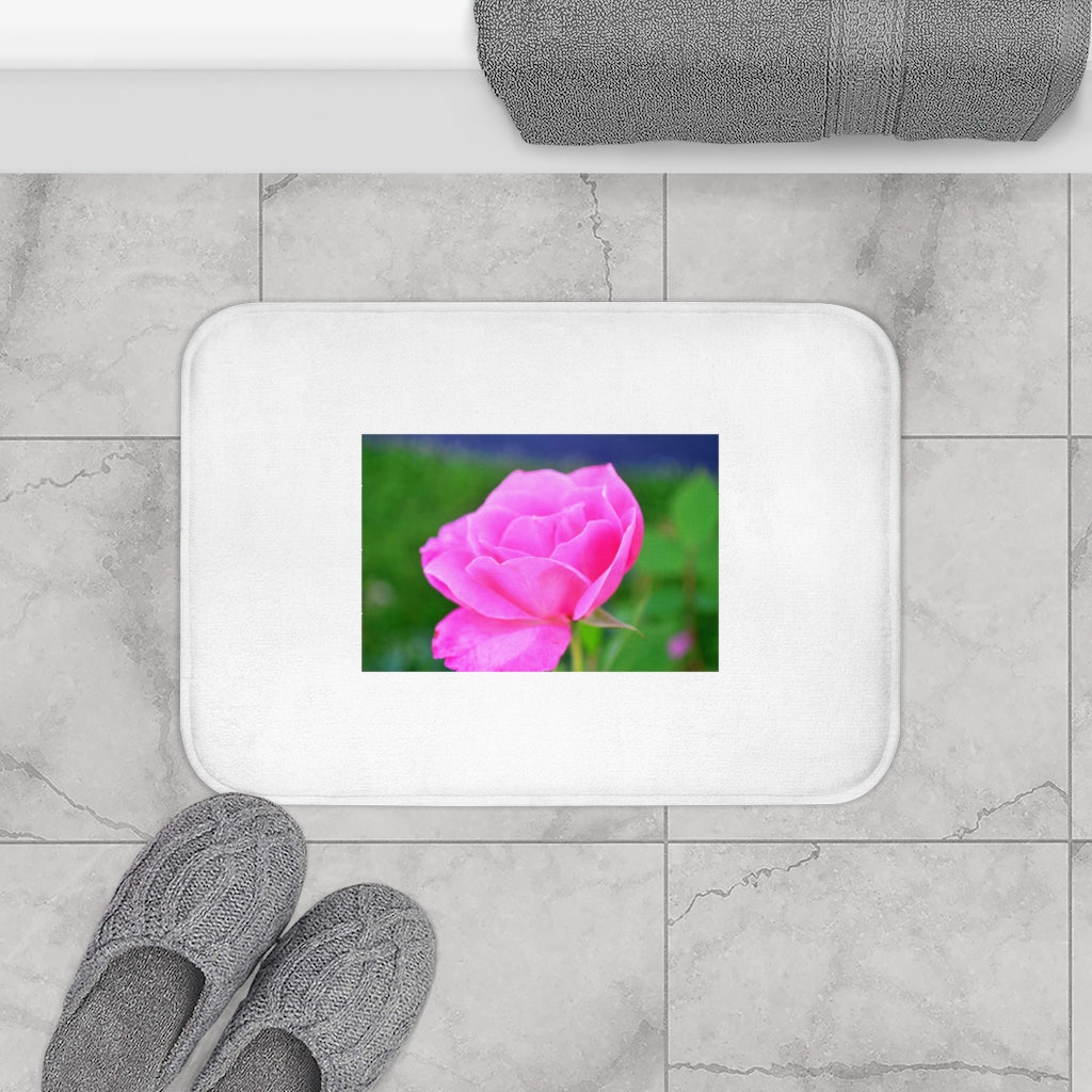 A soft pink flower bath mat with anti-slip backing, featuring vibrant floral patterns, perfect for enhancing bathroom decor.