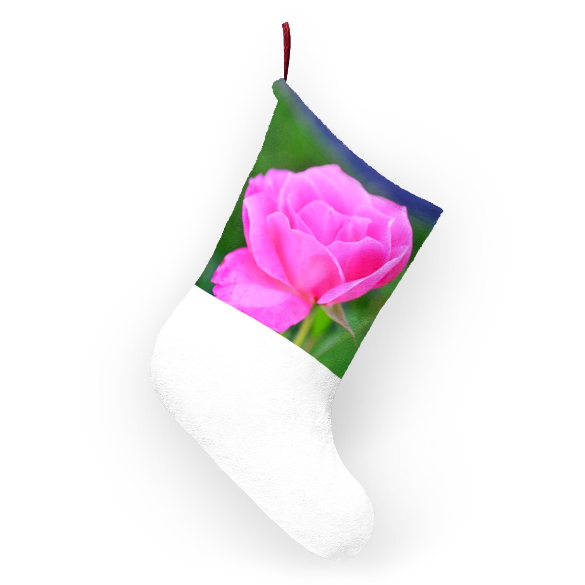 A pair of pink flower Christmas stockings hanging by a fireplace, featuring custom prints and a twill ribbon loop.