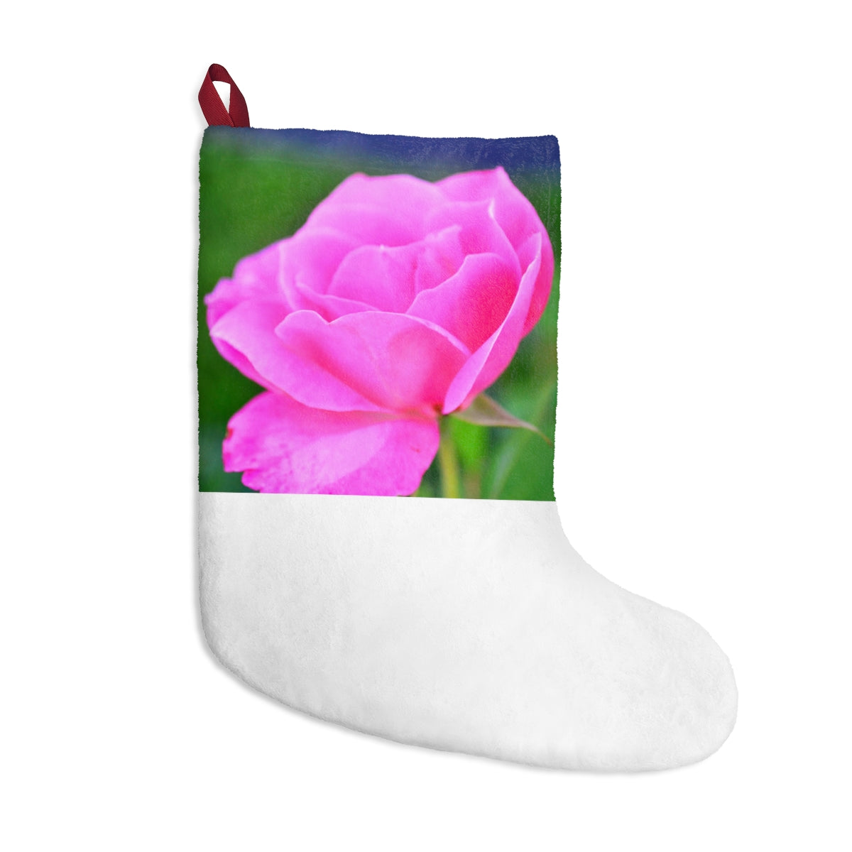 A pair of pink flower Christmas stockings hanging by a fireplace, featuring custom prints and a twill ribbon loop.