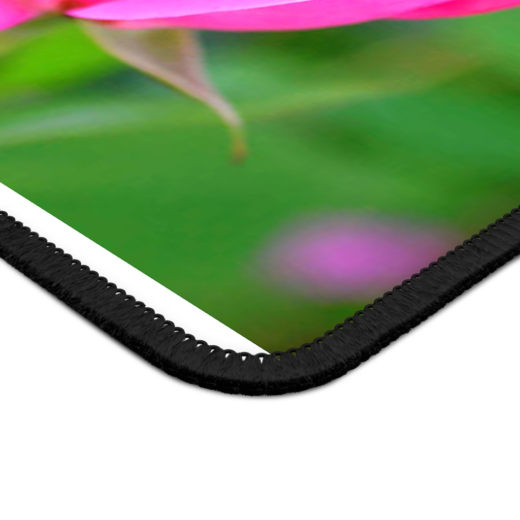 A vibrant pink flower gaming mouse pad with stitched edges, measuring 9x7 inches, designed for smooth performance and durability.