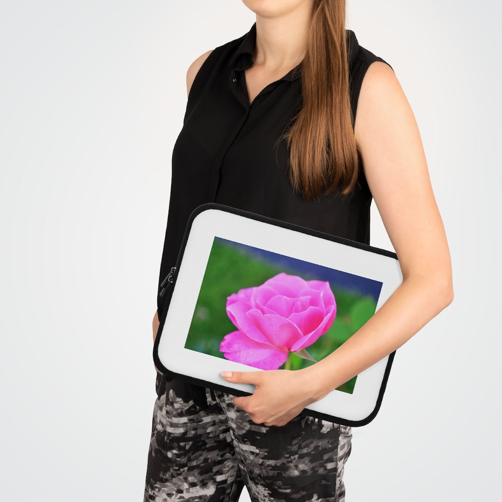 Pink Flower Laptop Sleeve featuring a vibrant floral design with a black polyester back, ideal for protecting laptops.