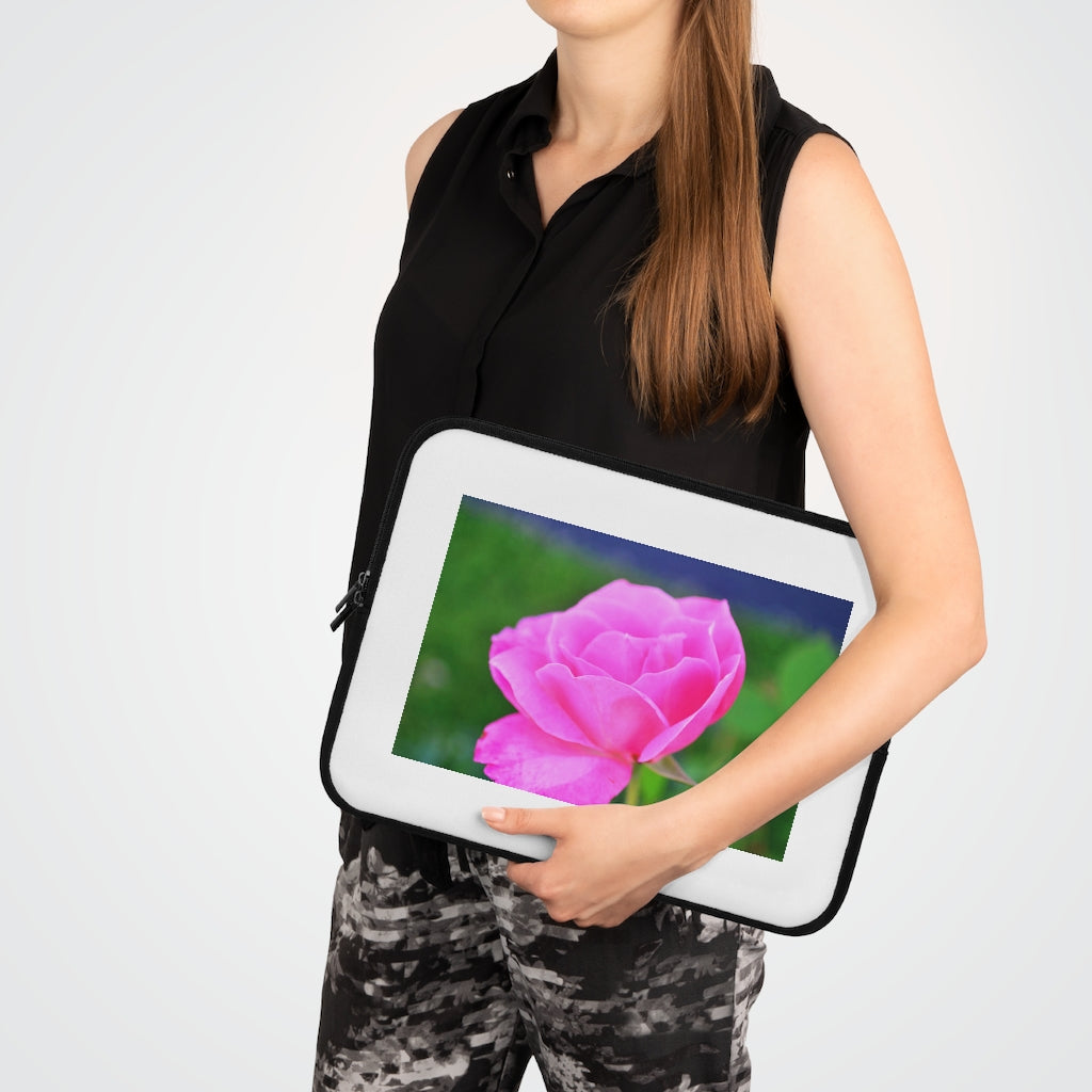 Pink Flower Laptop Sleeve featuring a vibrant floral design with a black polyester back, ideal for protecting laptops.