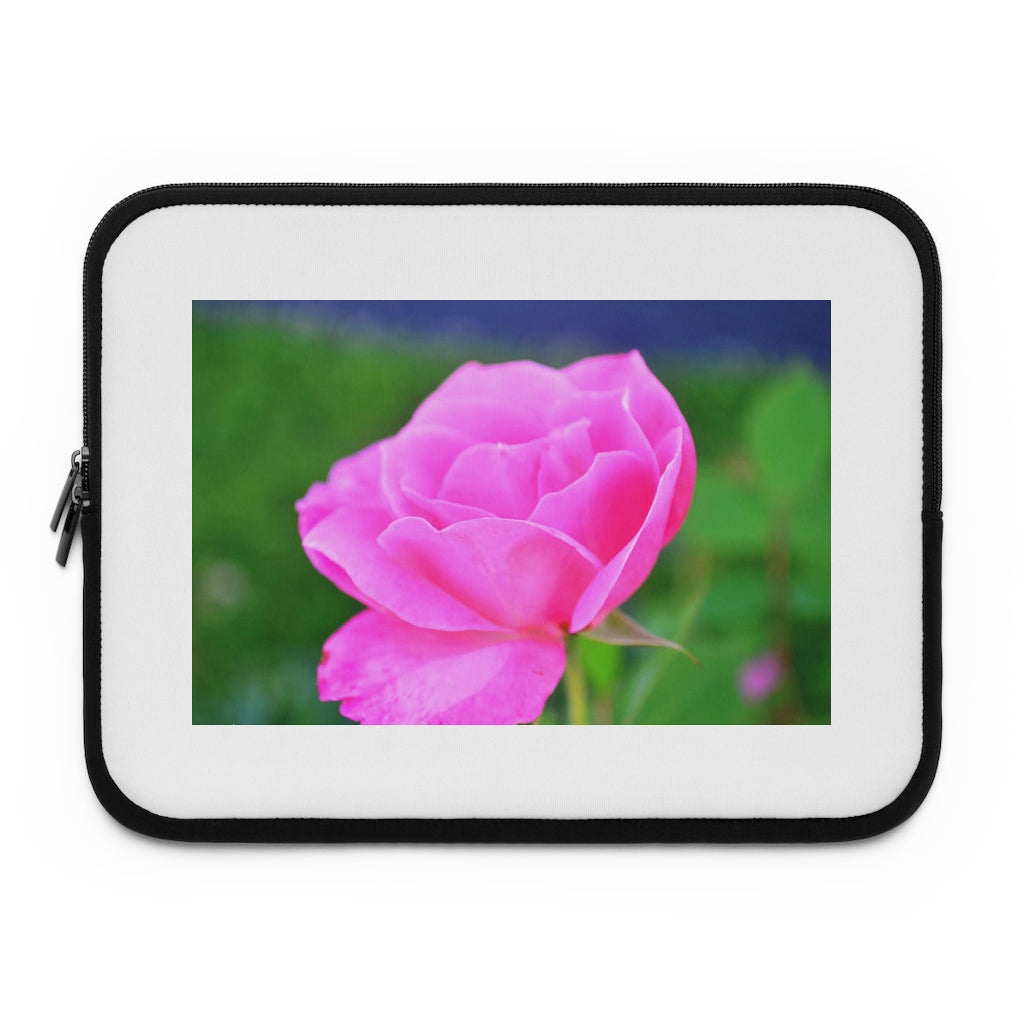 Pink Flower Laptop Sleeve featuring a vibrant floral design with a black polyester back, ideal for protecting laptops.