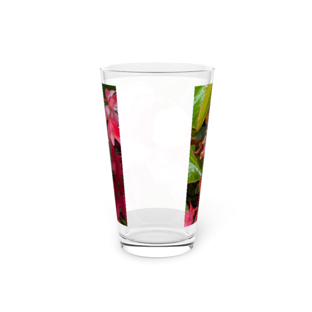 A clear 16oz pint glass featuring a pink flower design, perfect for personalized beverages.