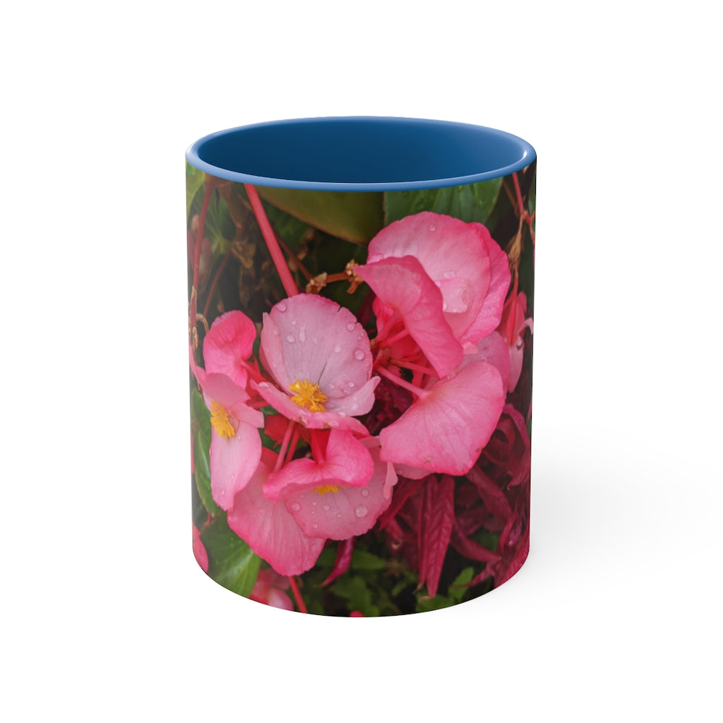 A vibrant pink flowers accent coffee mug with a white ceramic body and a contrasting colored interior and handle, showcasing its stylish design.