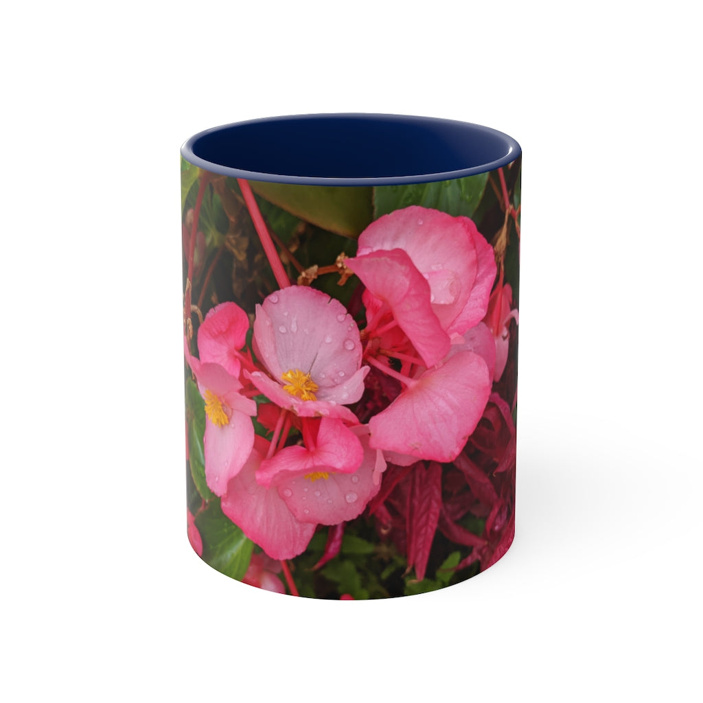 A vibrant pink flowers accent coffee mug with a white ceramic body and a contrasting colored interior and handle, showcasing its stylish design.