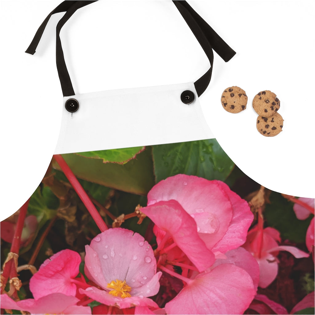 A stylish pink flowers apron with black detachable twill straps, perfect for cooking.