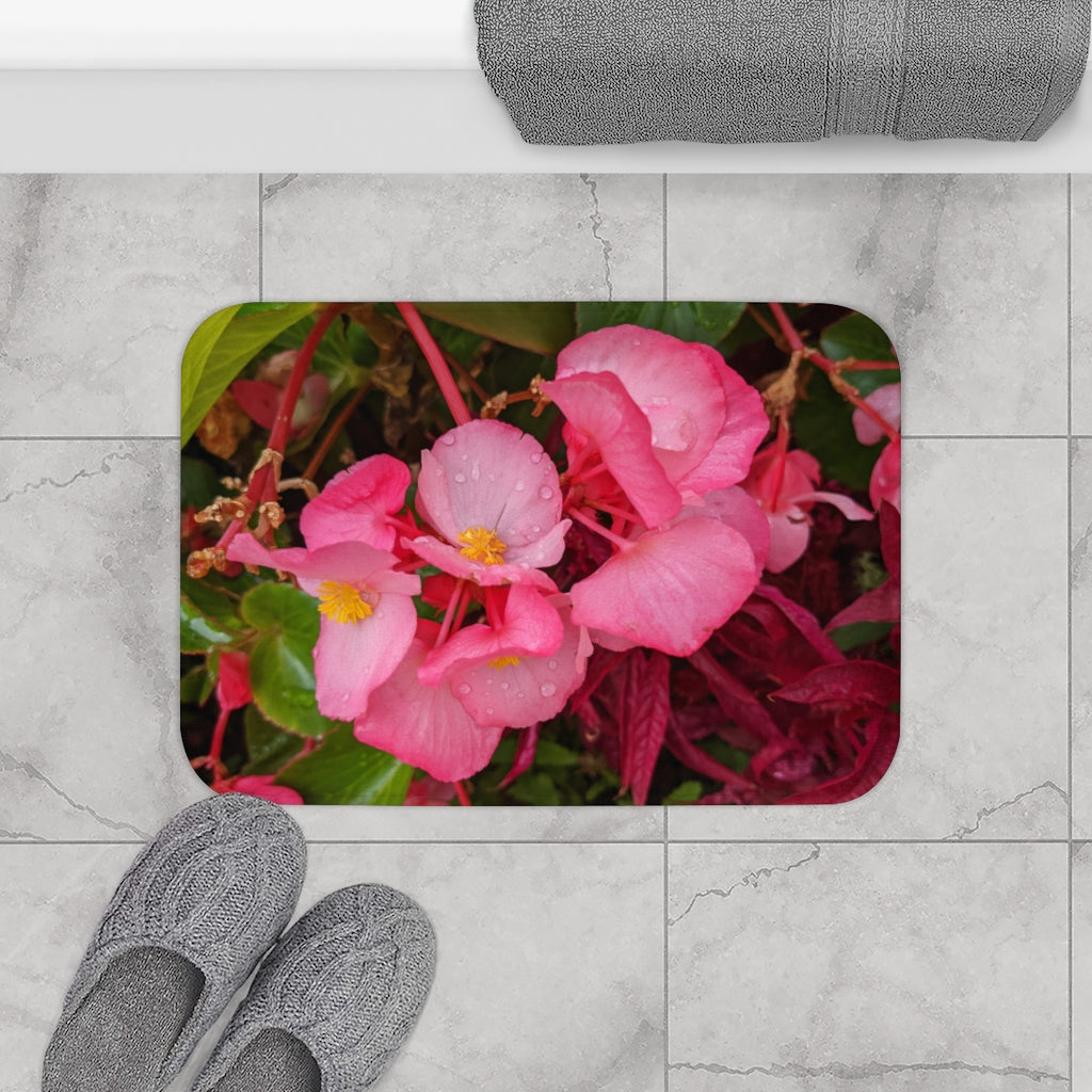 A soft pink flowers bath mat with anti-slip backing, featuring vibrant floral patterns, ideal for bathroom decor.