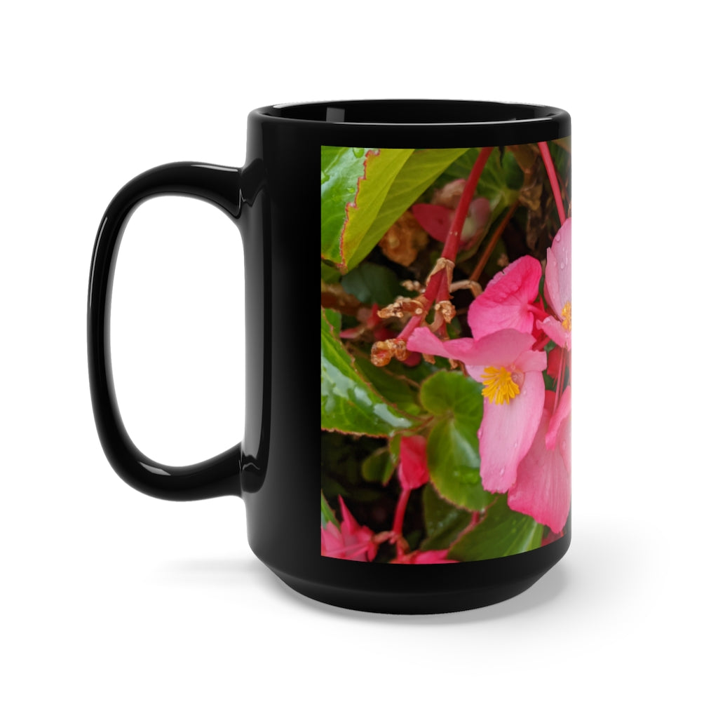 A stylish black ceramic mug featuring pink flowers design, perfect for coffee and tea lovers, with a comfortable C-handle.