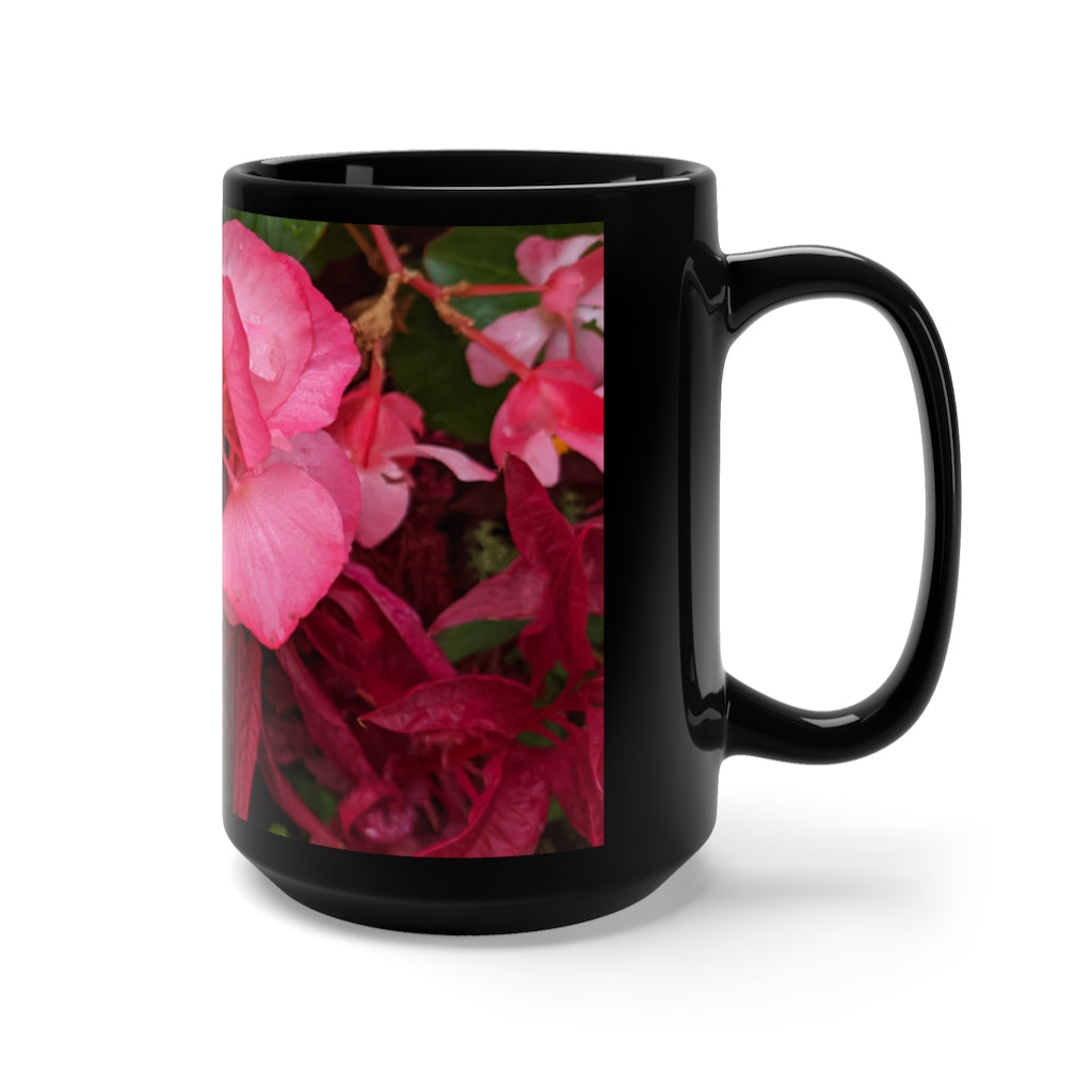 A stylish black ceramic mug featuring pink flowers design, perfect for coffee and tea lovers, with a comfortable C-handle.